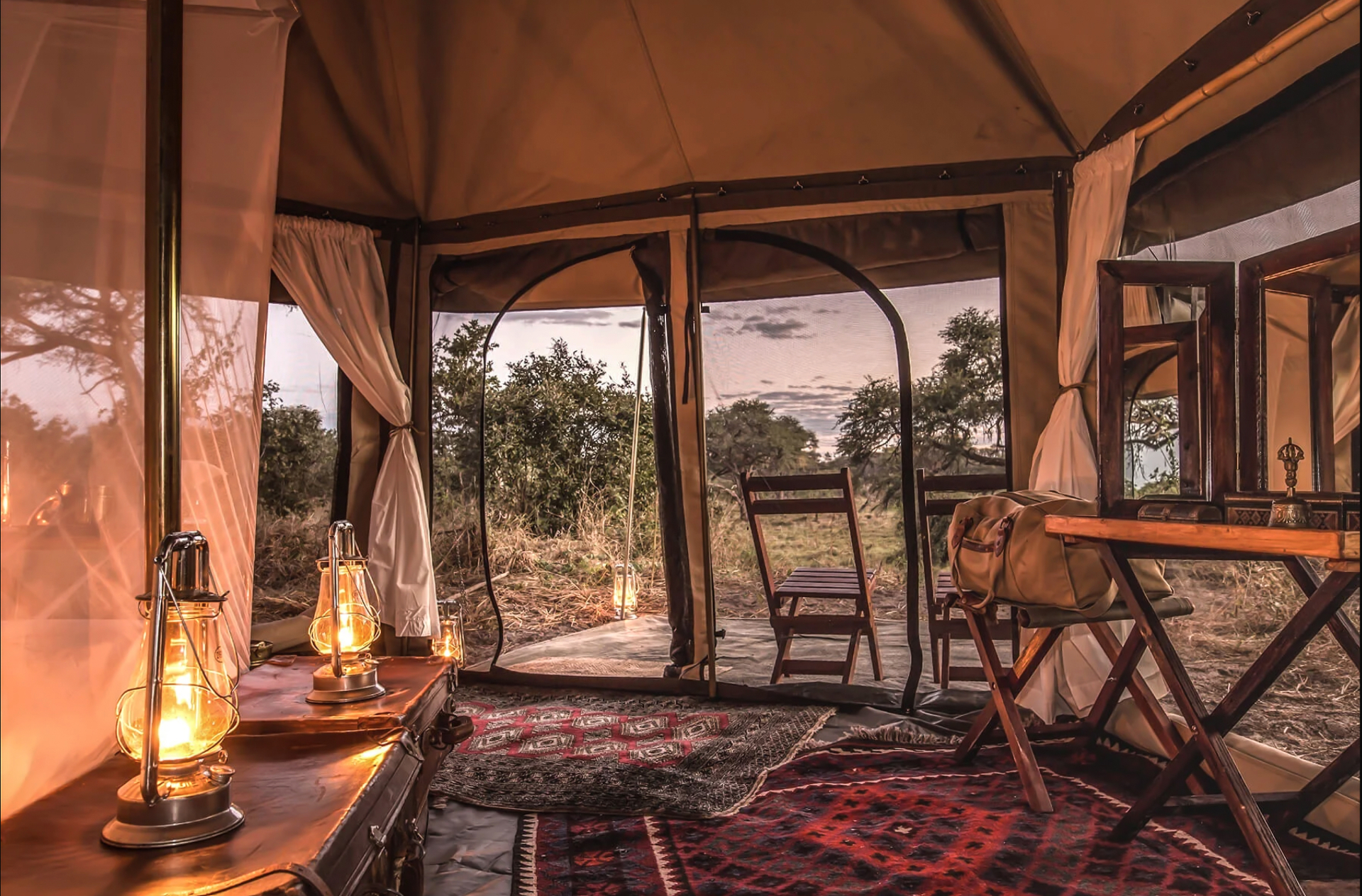 Lantern-lit safari tent interior at dusk