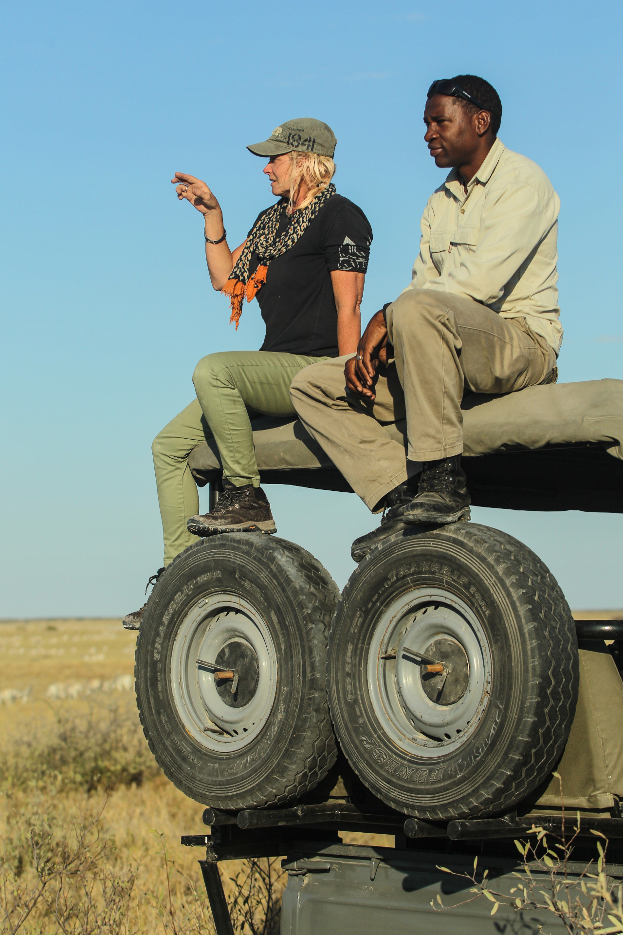 Jytte and Disho scouting from the top of the safari vehicle